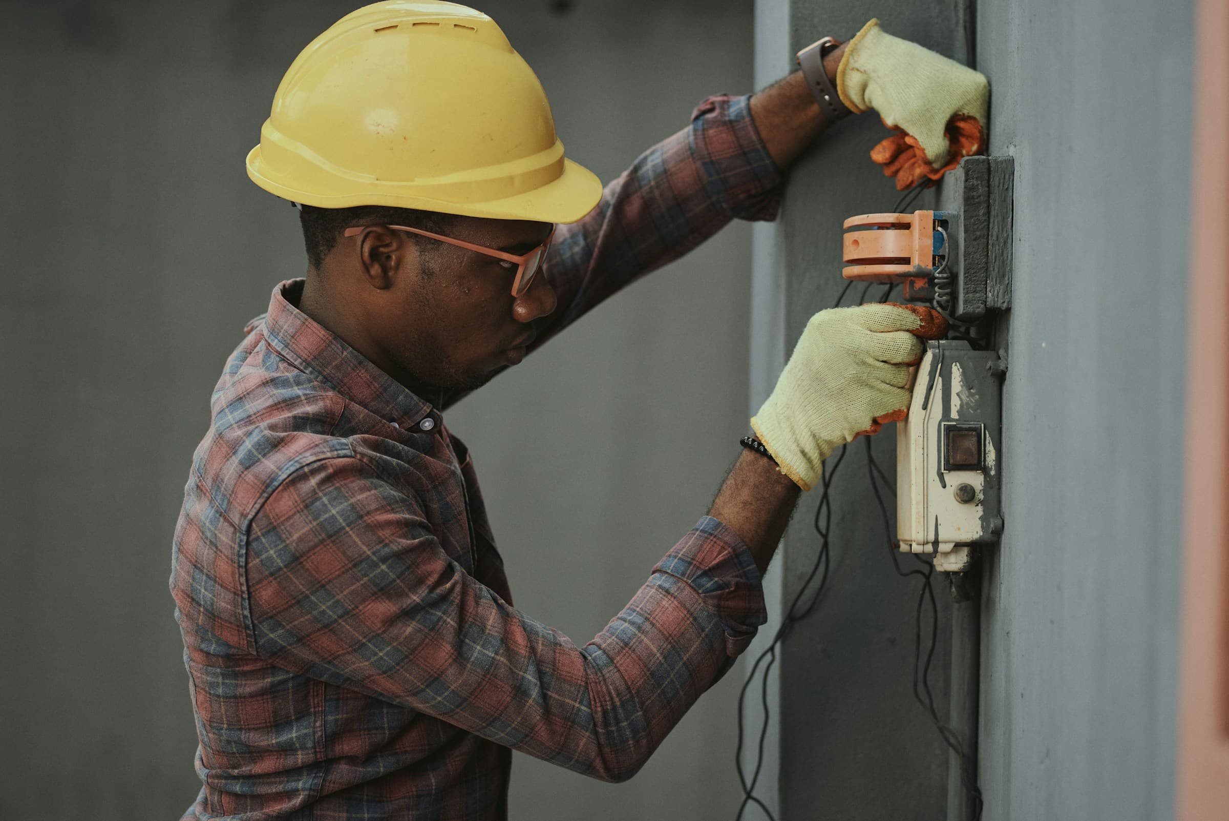 Technician calibrating infrastructure systems — precision hands, controlled operational environment